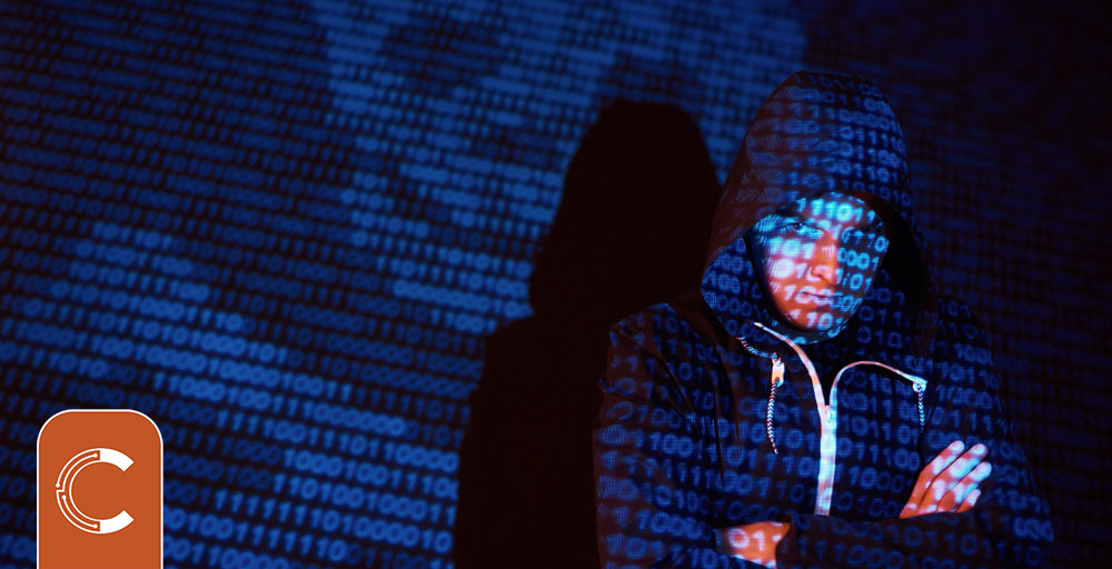 cyber-attack-with-unrecognizable-hooded-hacker-using-virtual-reality-digital-glitch-effect-1000x512.jpg